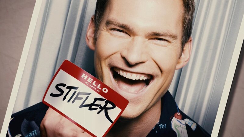 Man holding name tag with 'Stifler' written on it