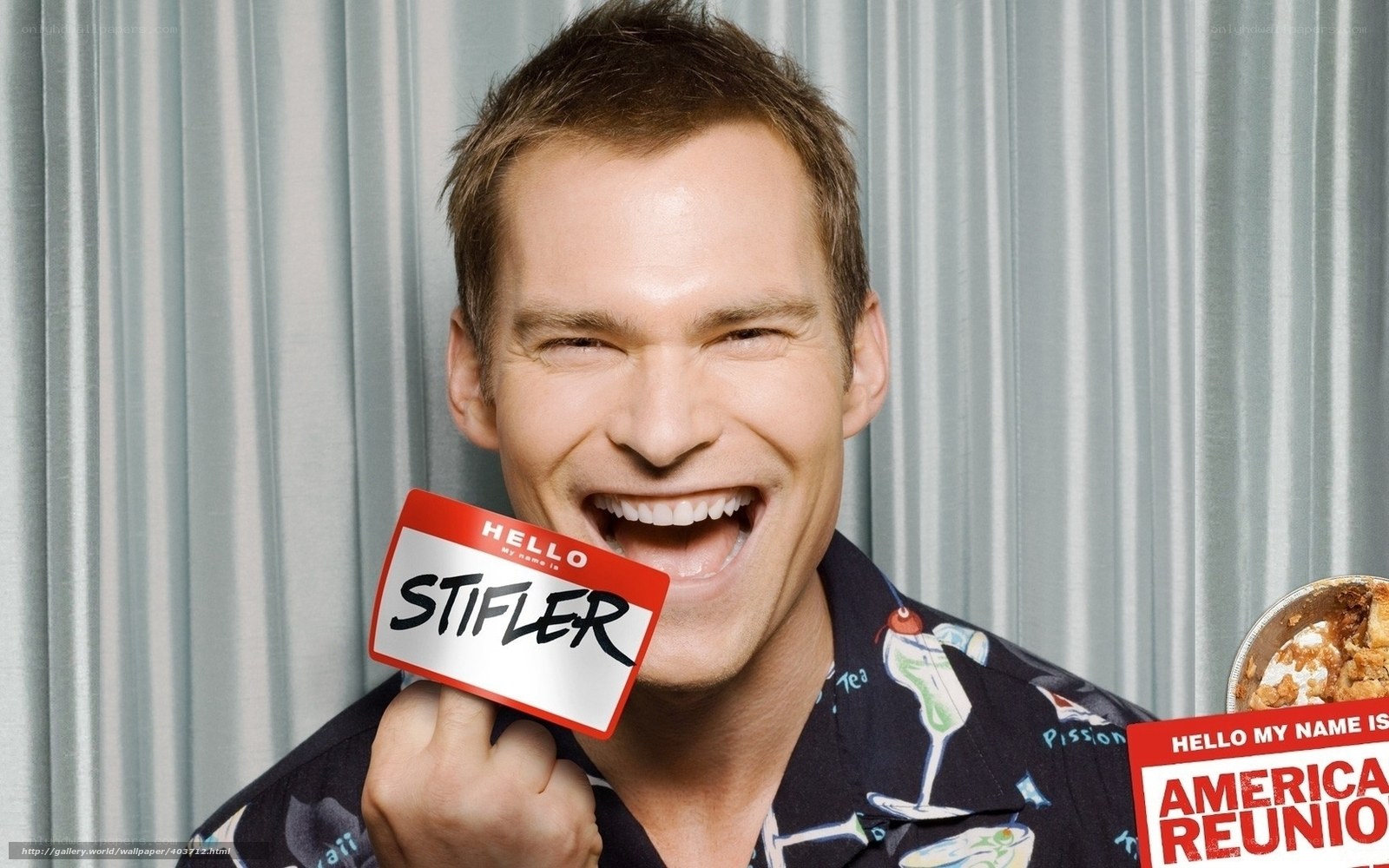 Man holding name tag with 'Stifler'
