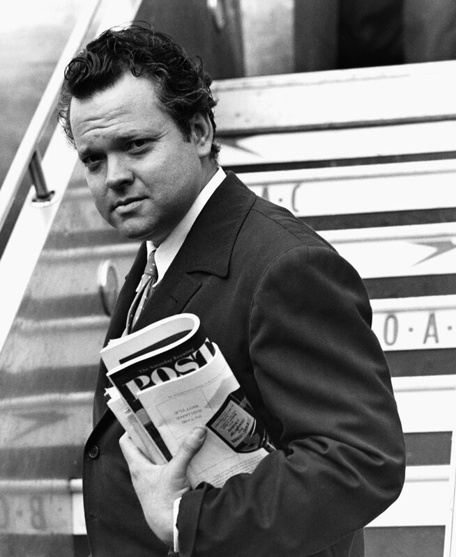 Man holding newspaper on stairs