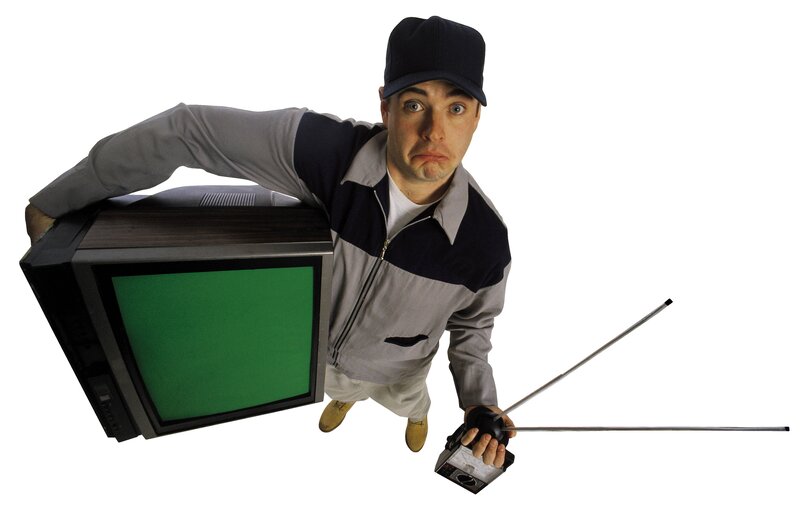 man holding old television