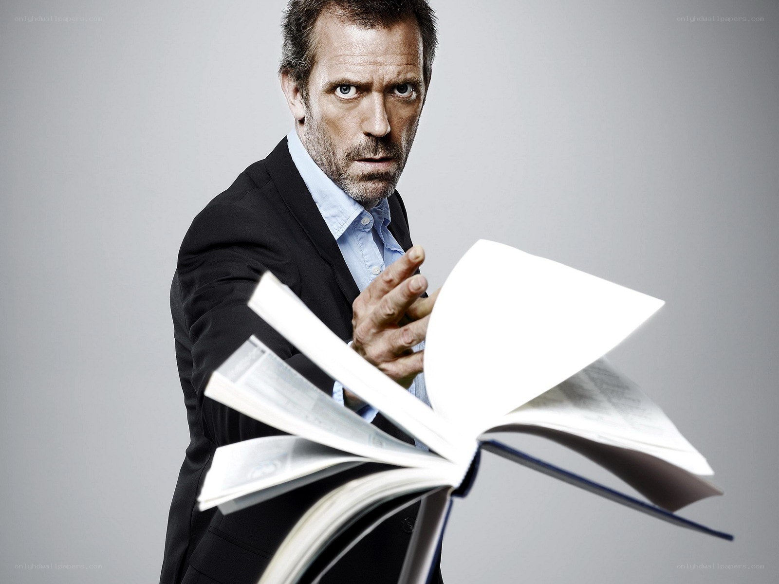 man holding open book