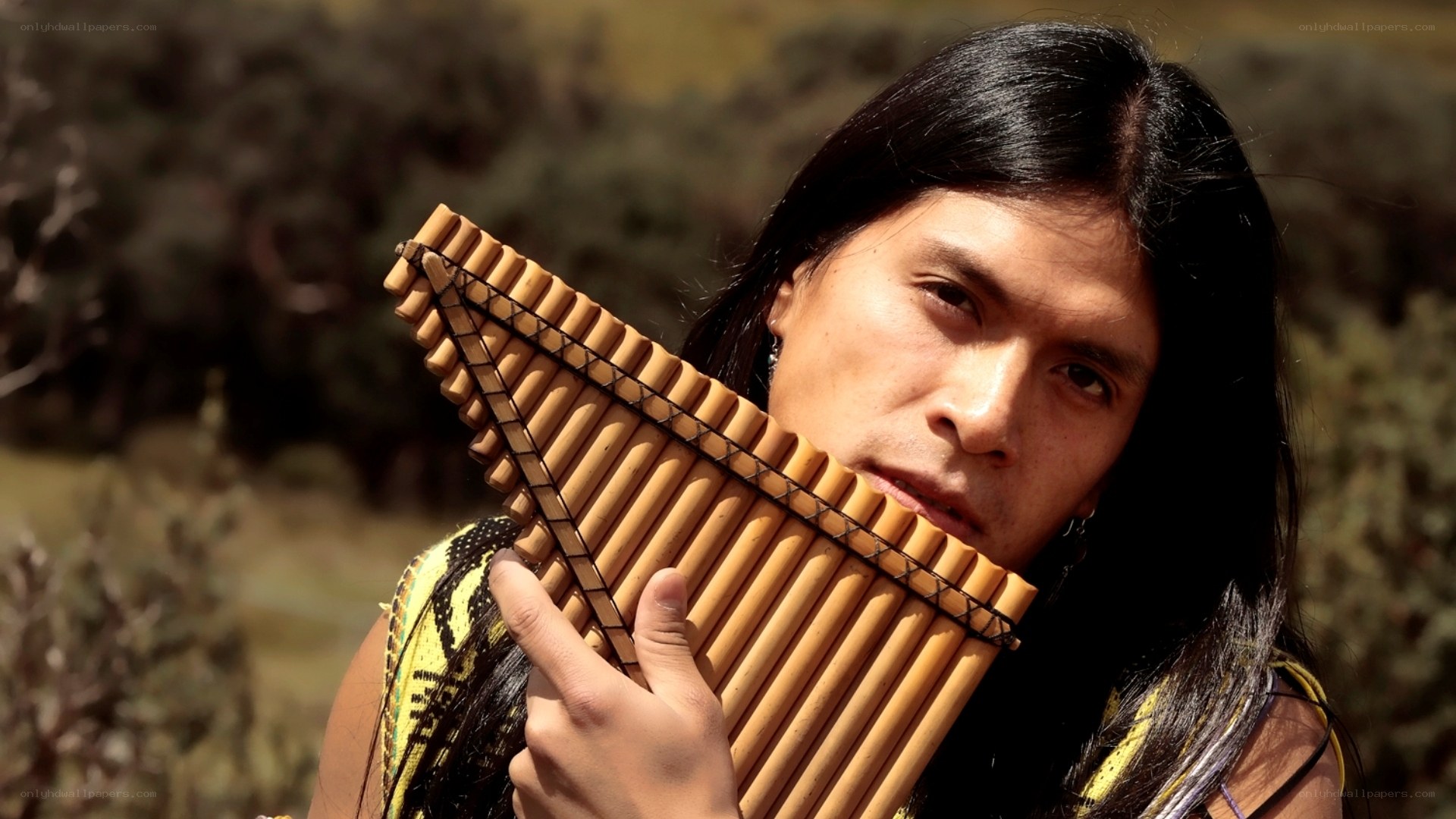 man holding pan flute