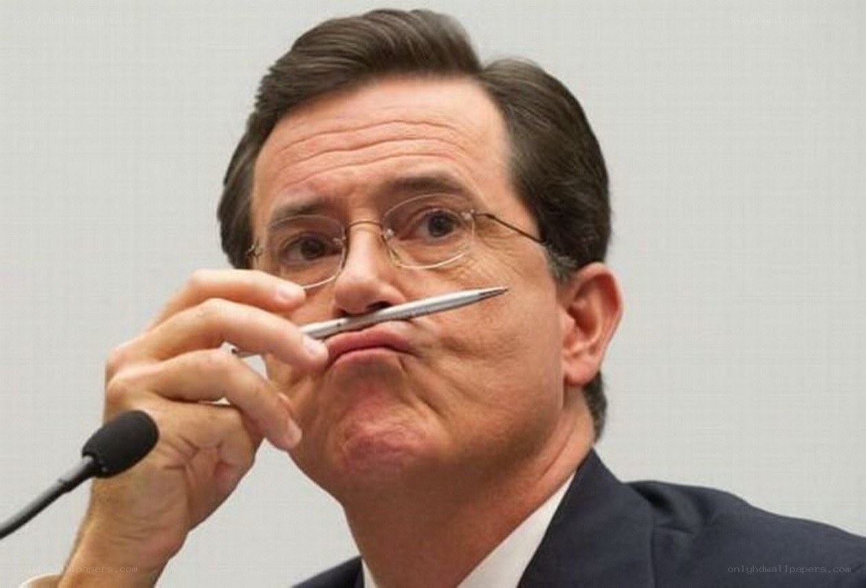 man holding pen to face