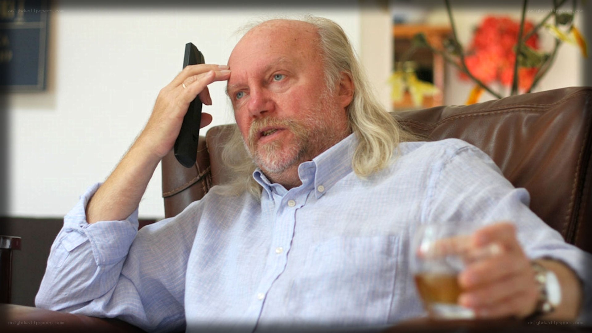 man holding phone and drink