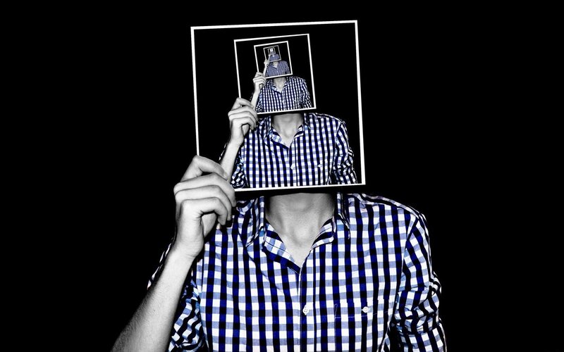 man holding photo of himself