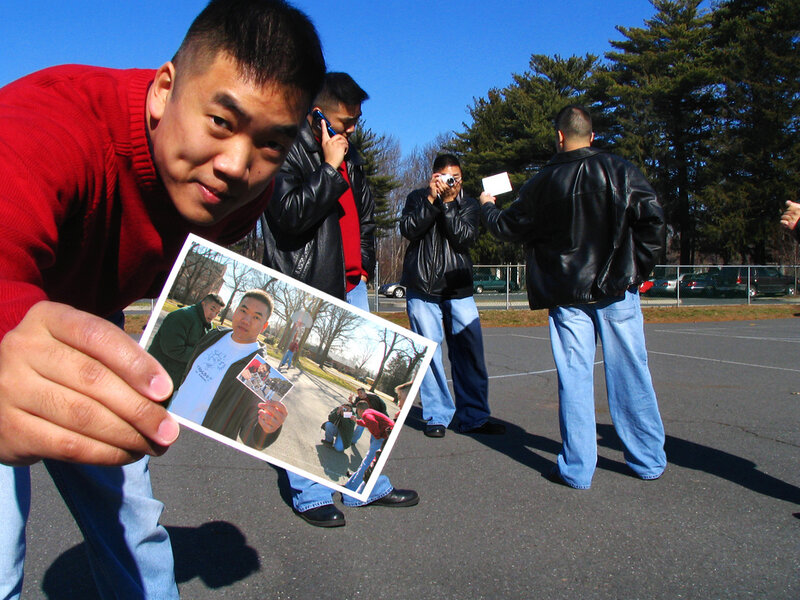 man holding photo outdoors
