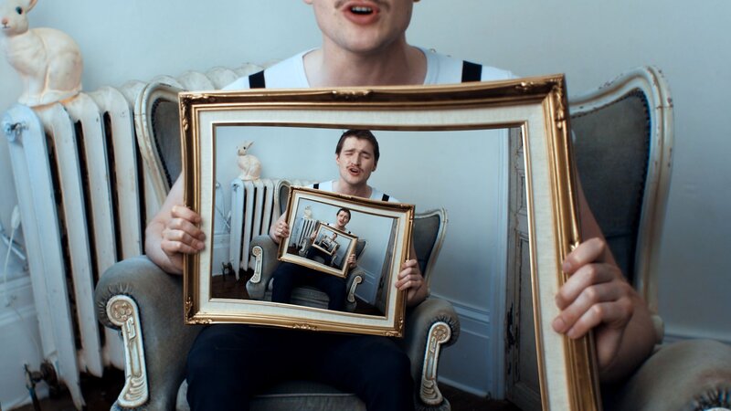 man holding picture frame