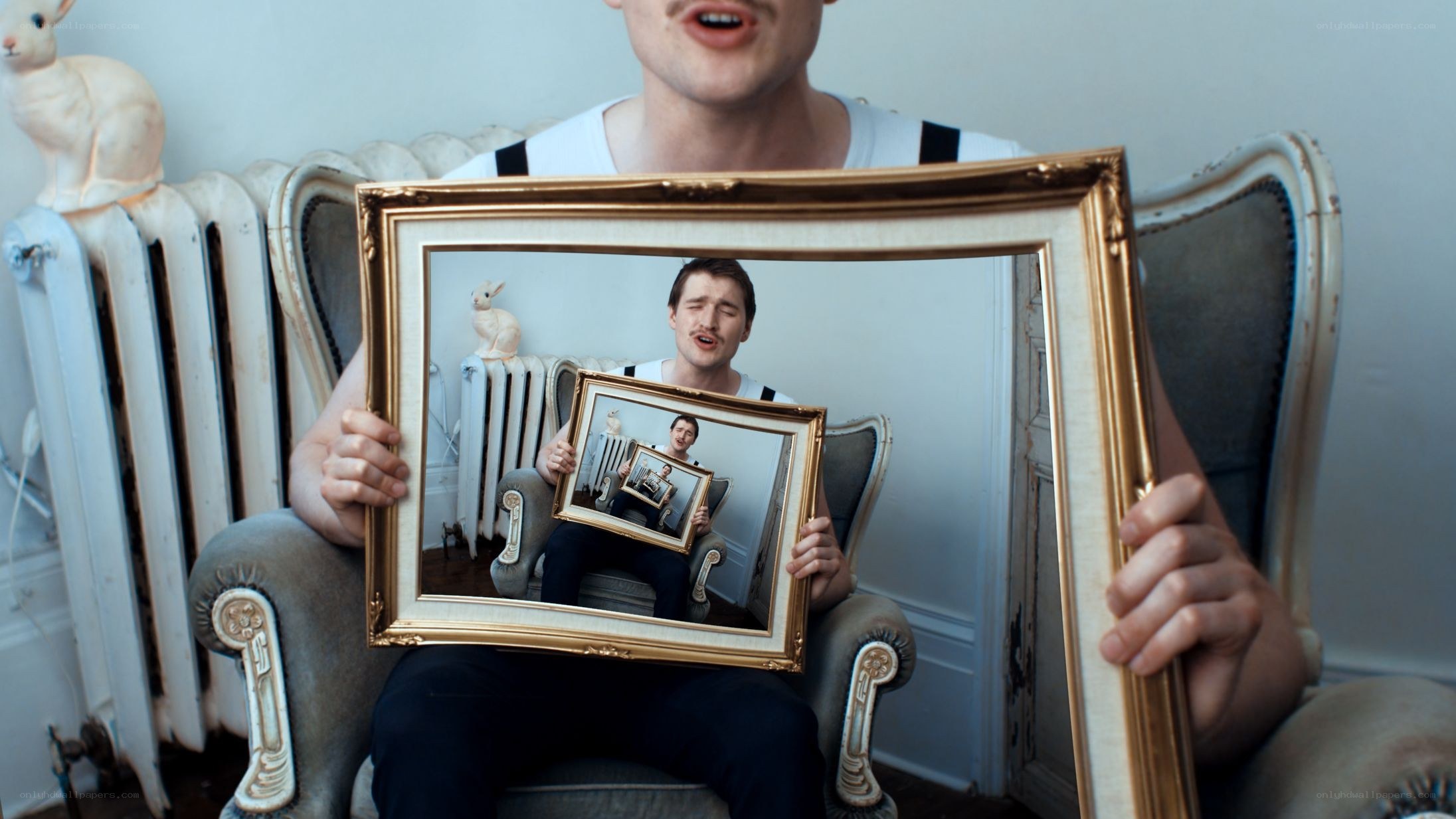 man holding picture frame