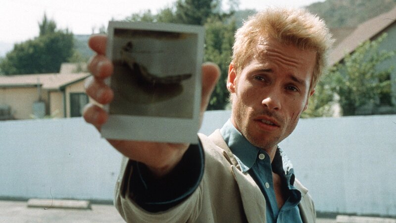 man holding polaroid photo