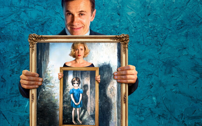 Man holding portrait of woman and girl
