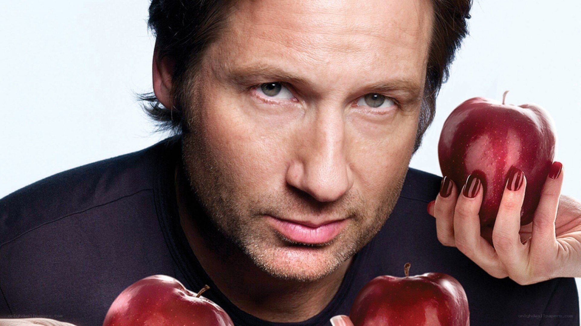 man holding red apples