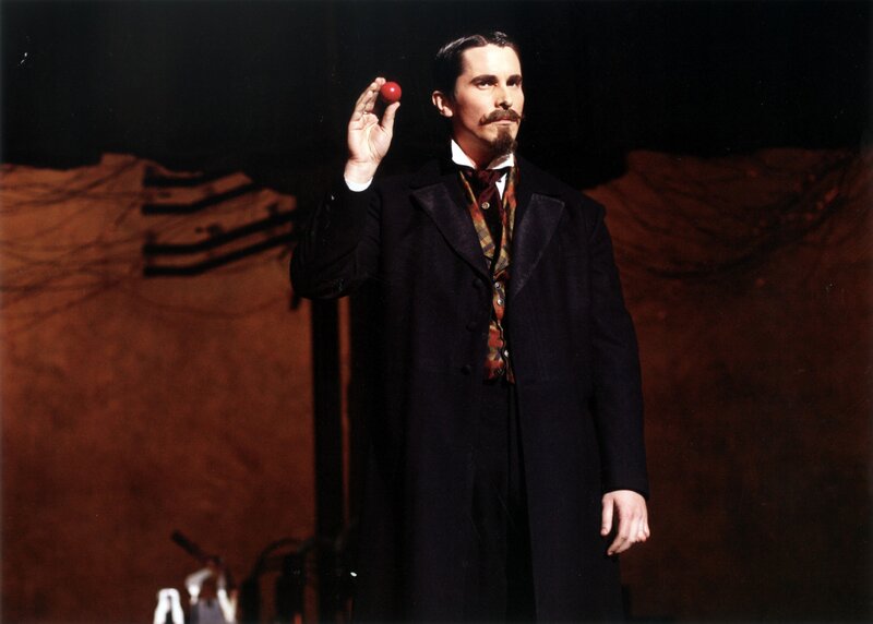 Man holding red ball on stage