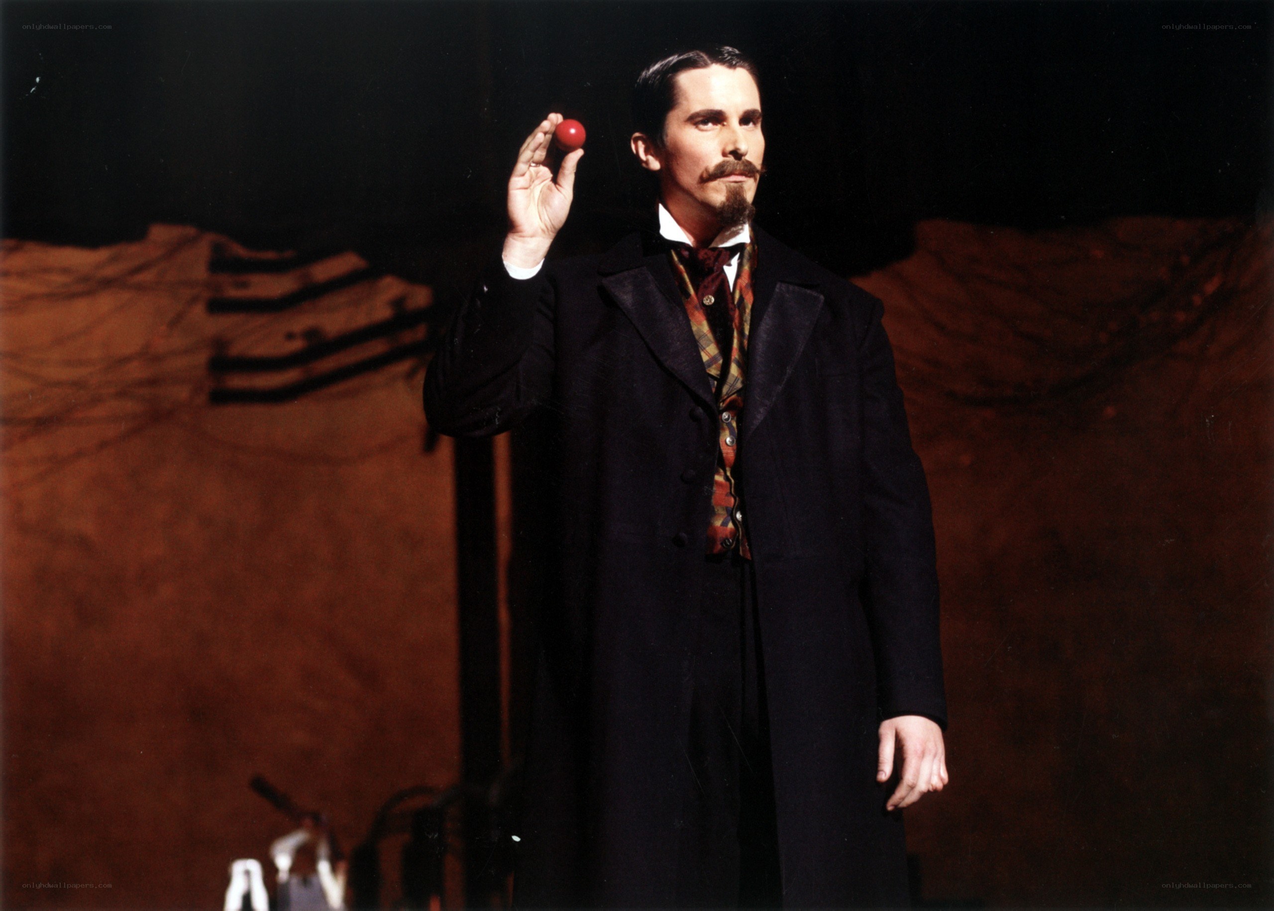 Man holding red ball on stage