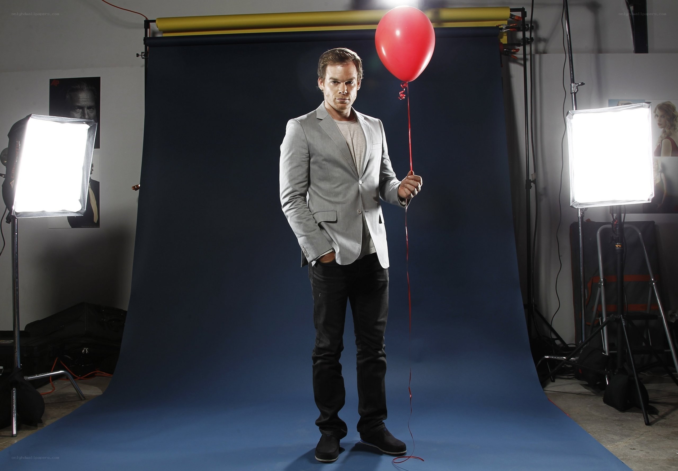 Man holding red balloon in studio