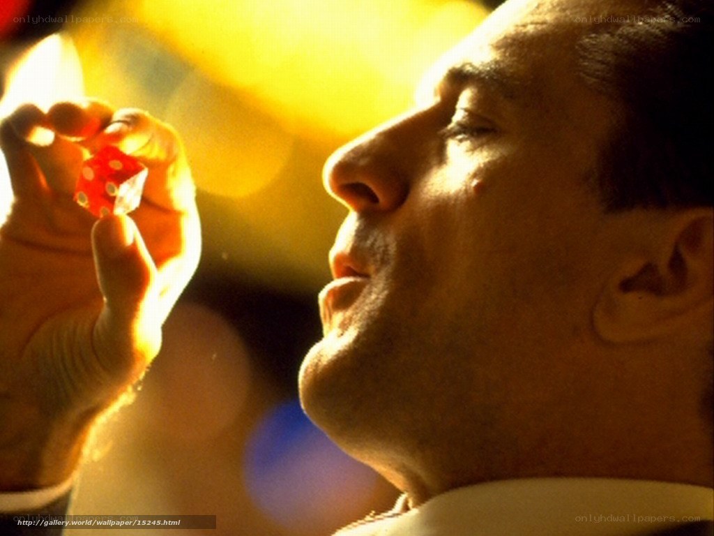 man holding red die