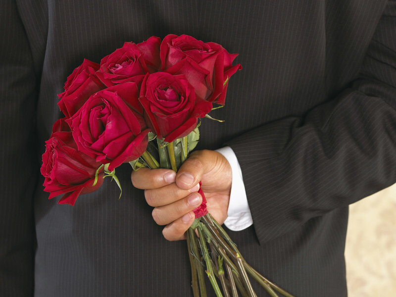 man holding red roses