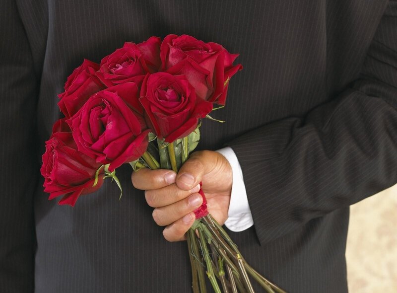 man holding red roses
