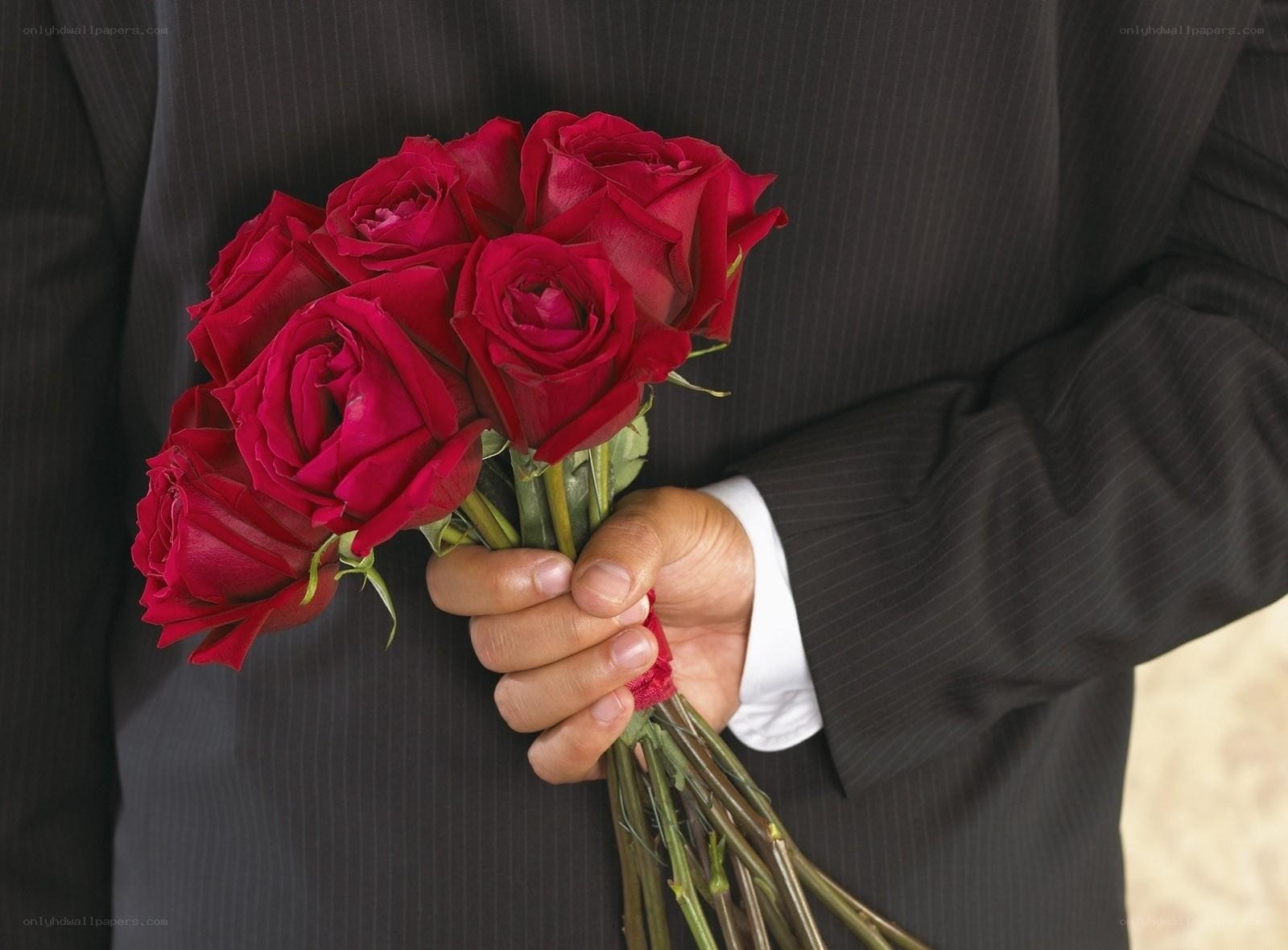 man holding red roses