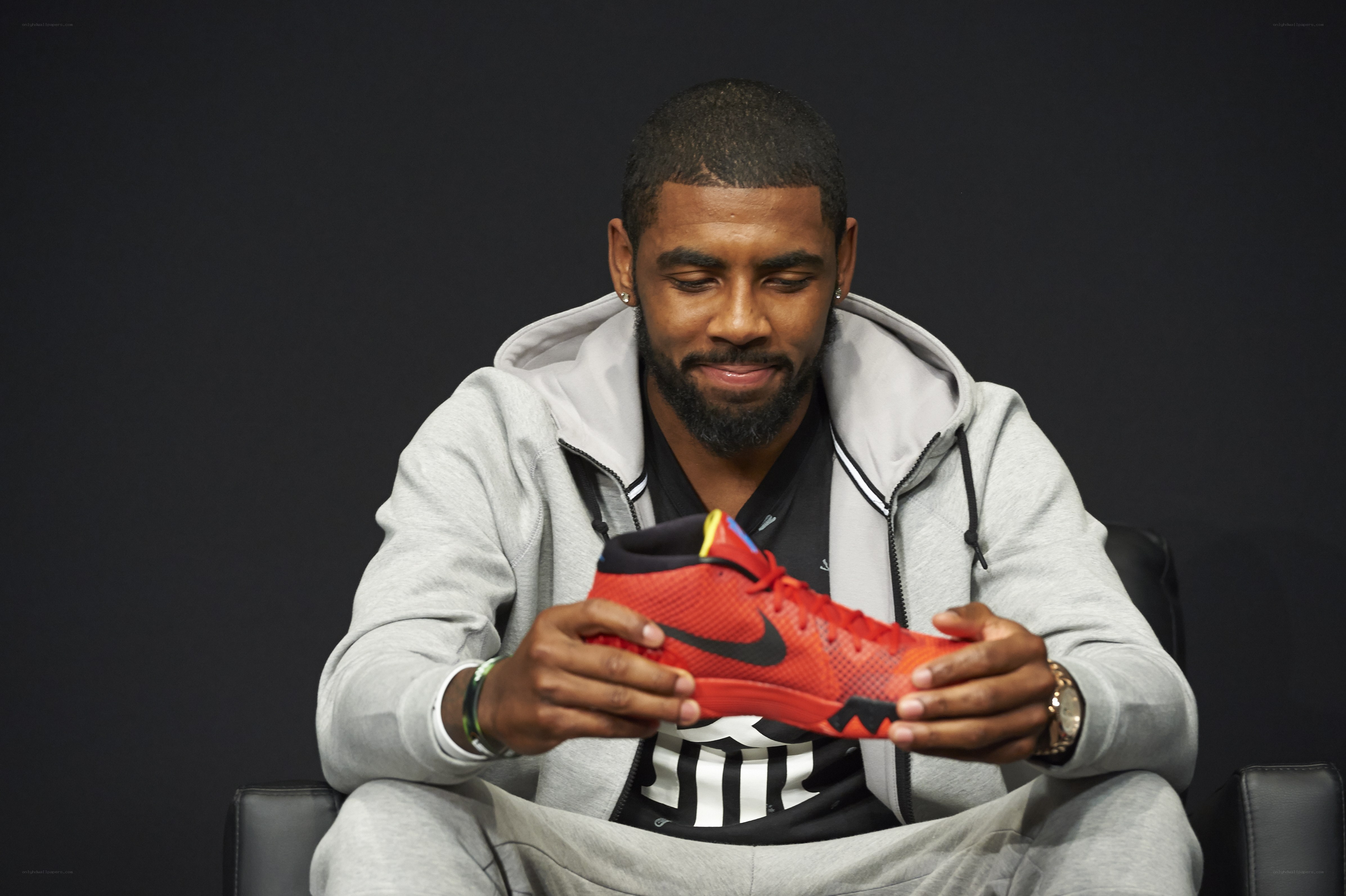 man holding red sneaker