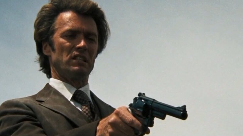 Man Holding Revolver — Brown, Dramatic