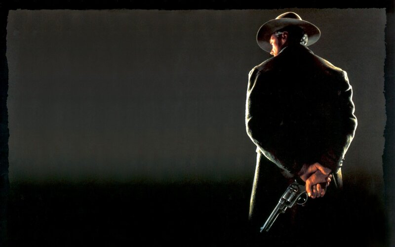 man holding revolver in dark