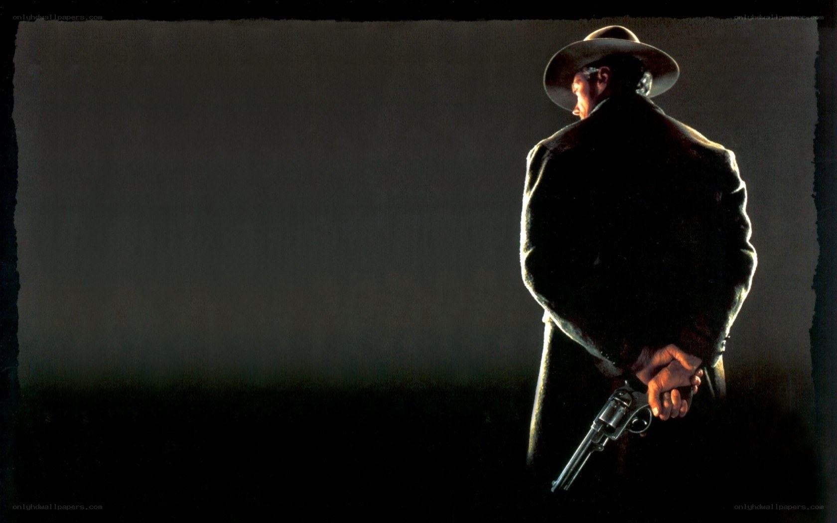 man holding revolver in dark