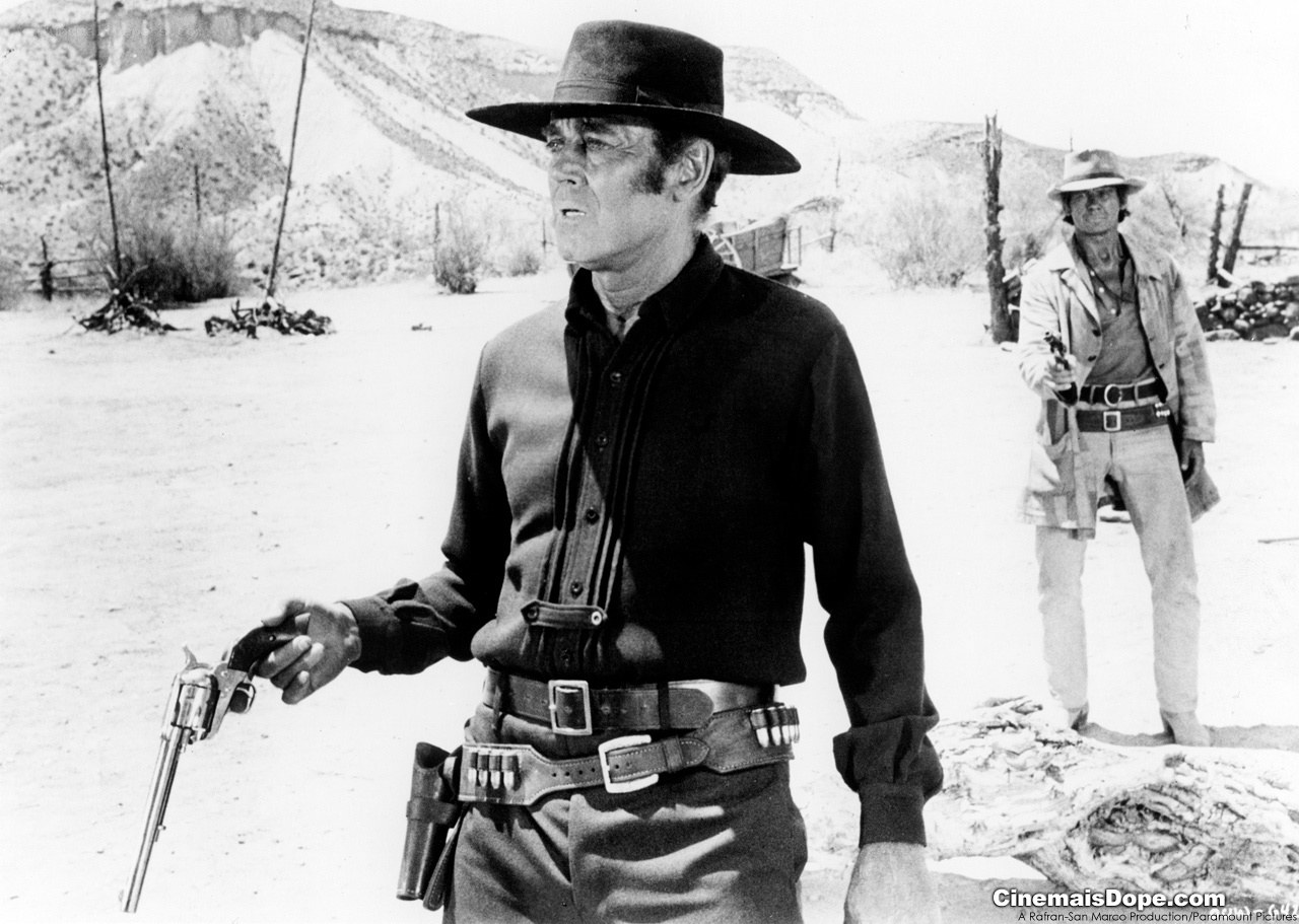 Man holding revolver in desert