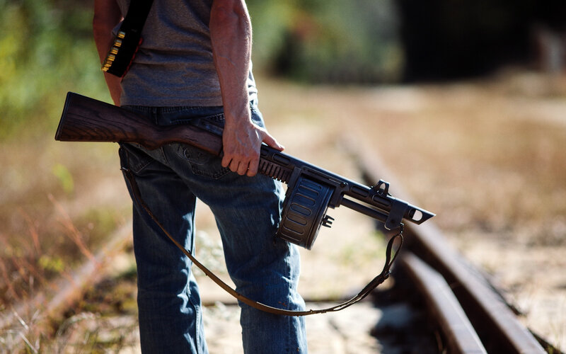 Man Holding Rifle — Brown, Dramatic, Afternoon