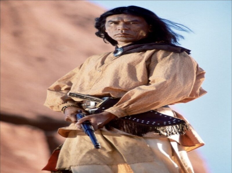 Man Holding Rifle — Brown, Serious