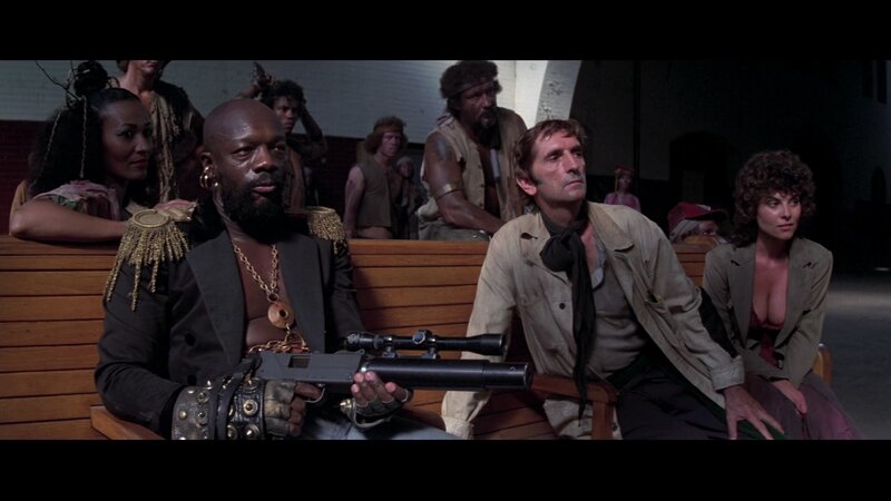 Man Holding Rifle — Brown, Tense