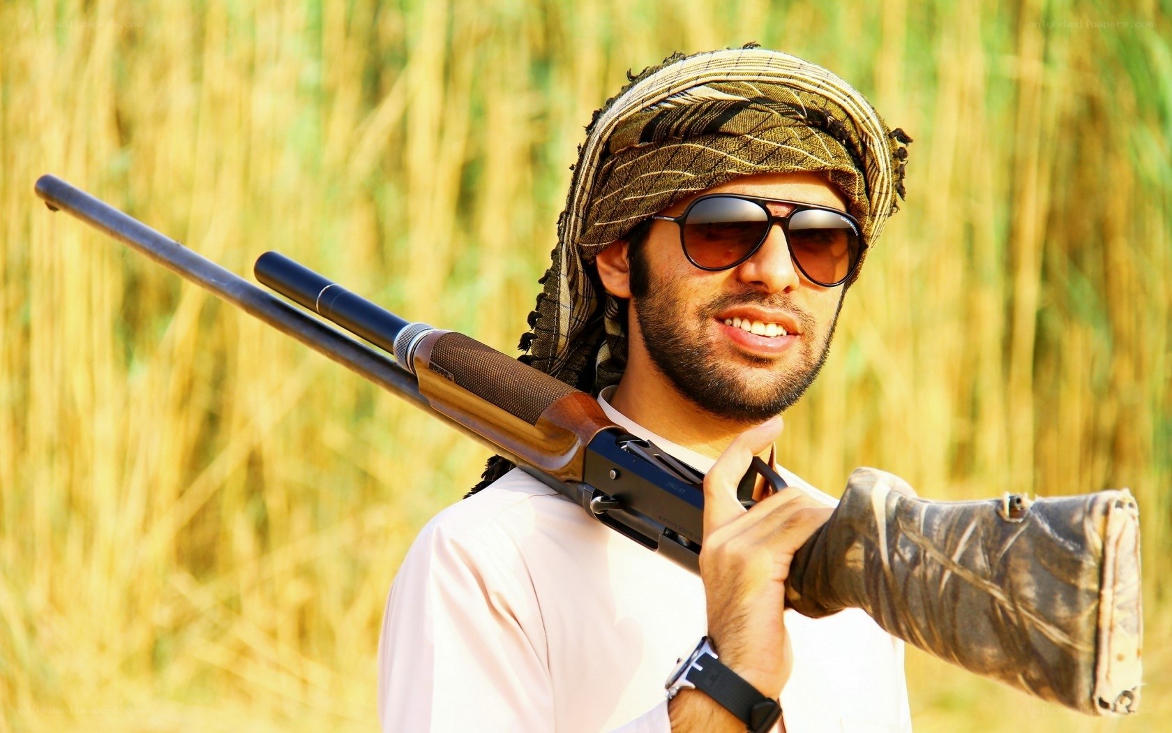 man holding rifle in field