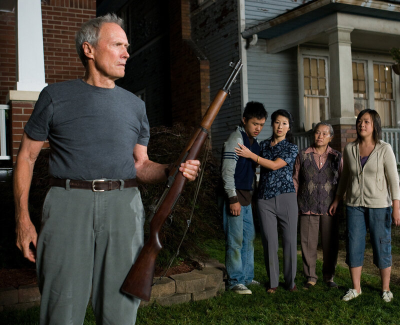 Man Holding Rifle with Family