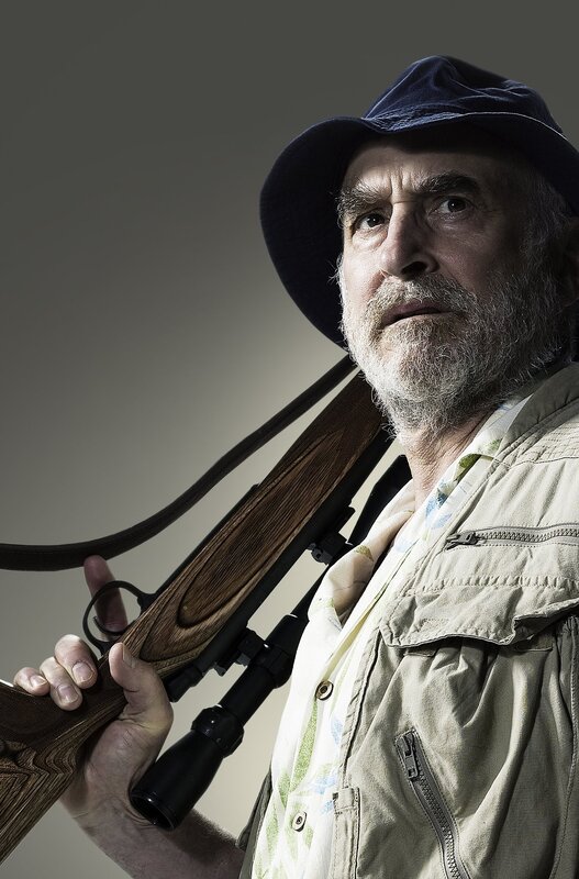 man holding rifle with scope
