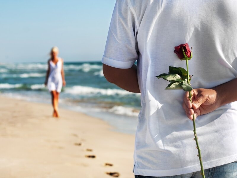 Man Holding Rose on Beach