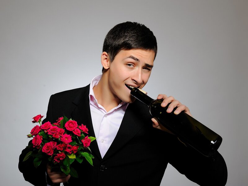 Man Holding Roses and Bottle