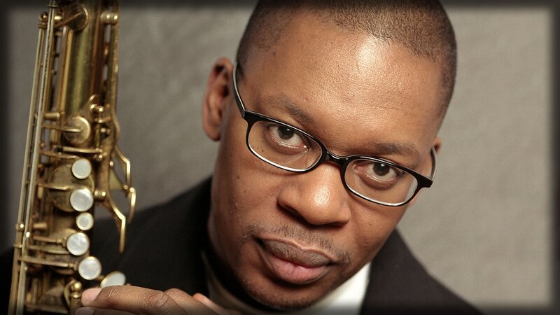 Man Holding Saxophone — Black