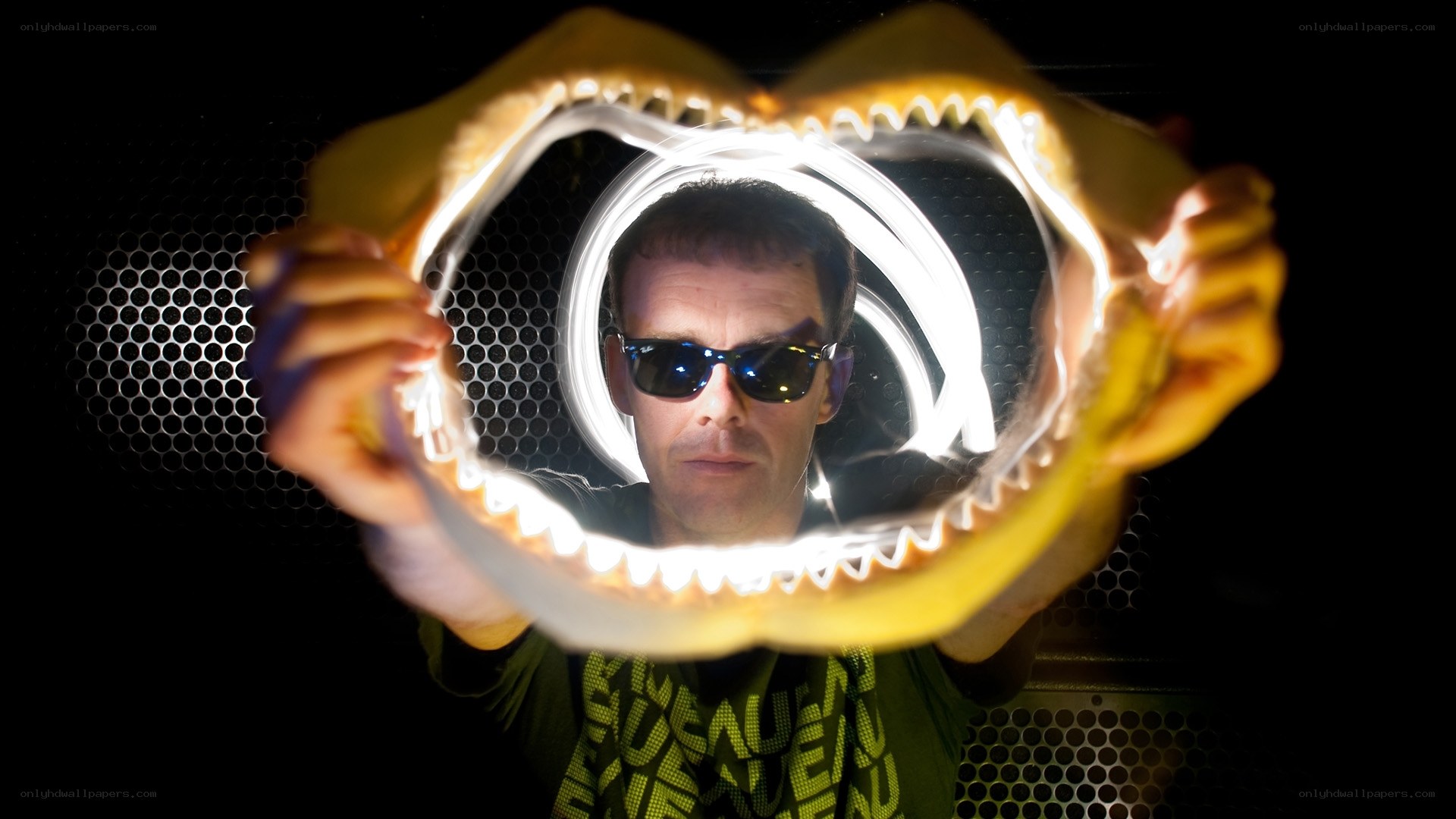 Man holding shark jaw in light art