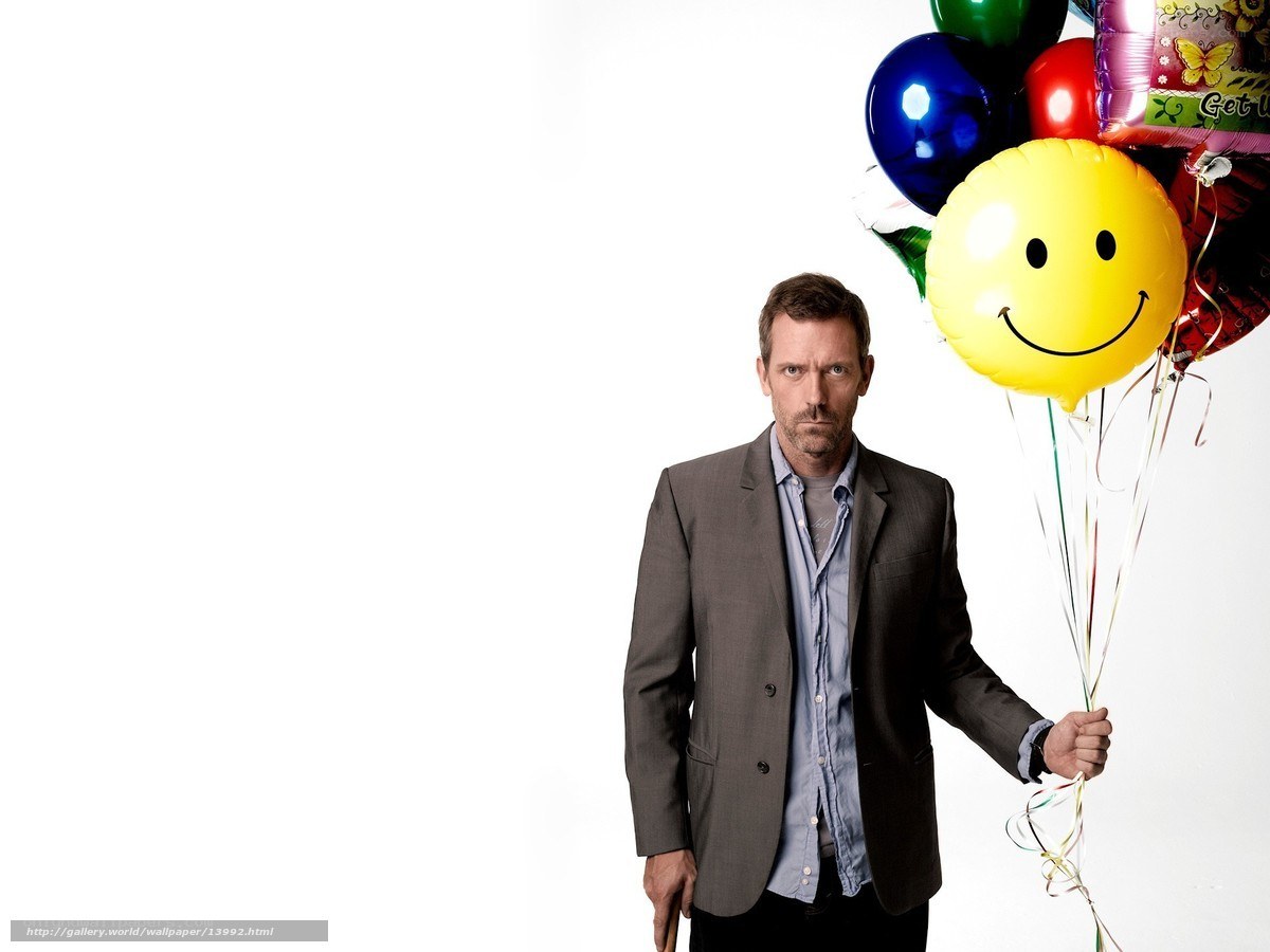 man holding smiley balloon