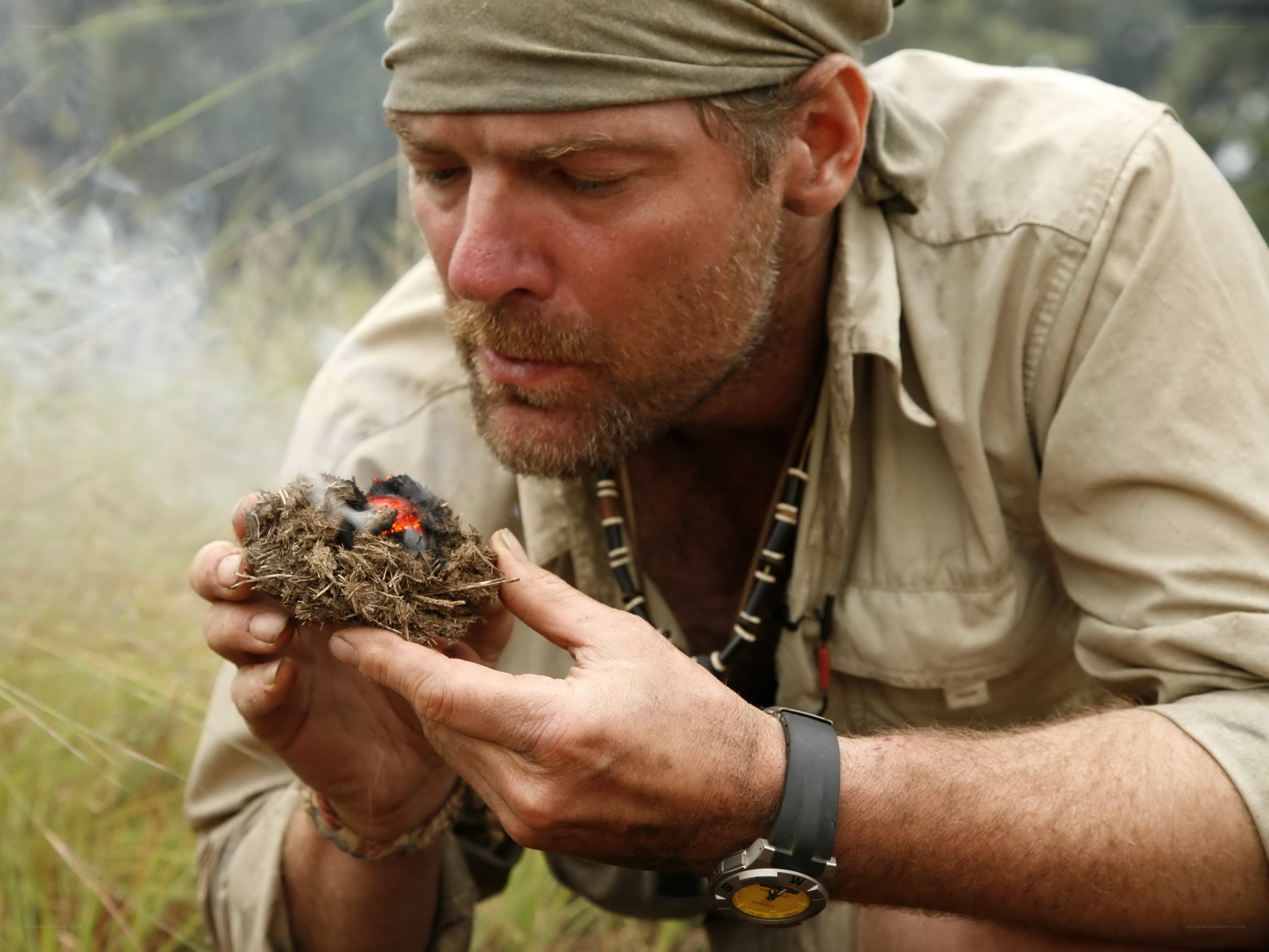 man holding smoldering nest