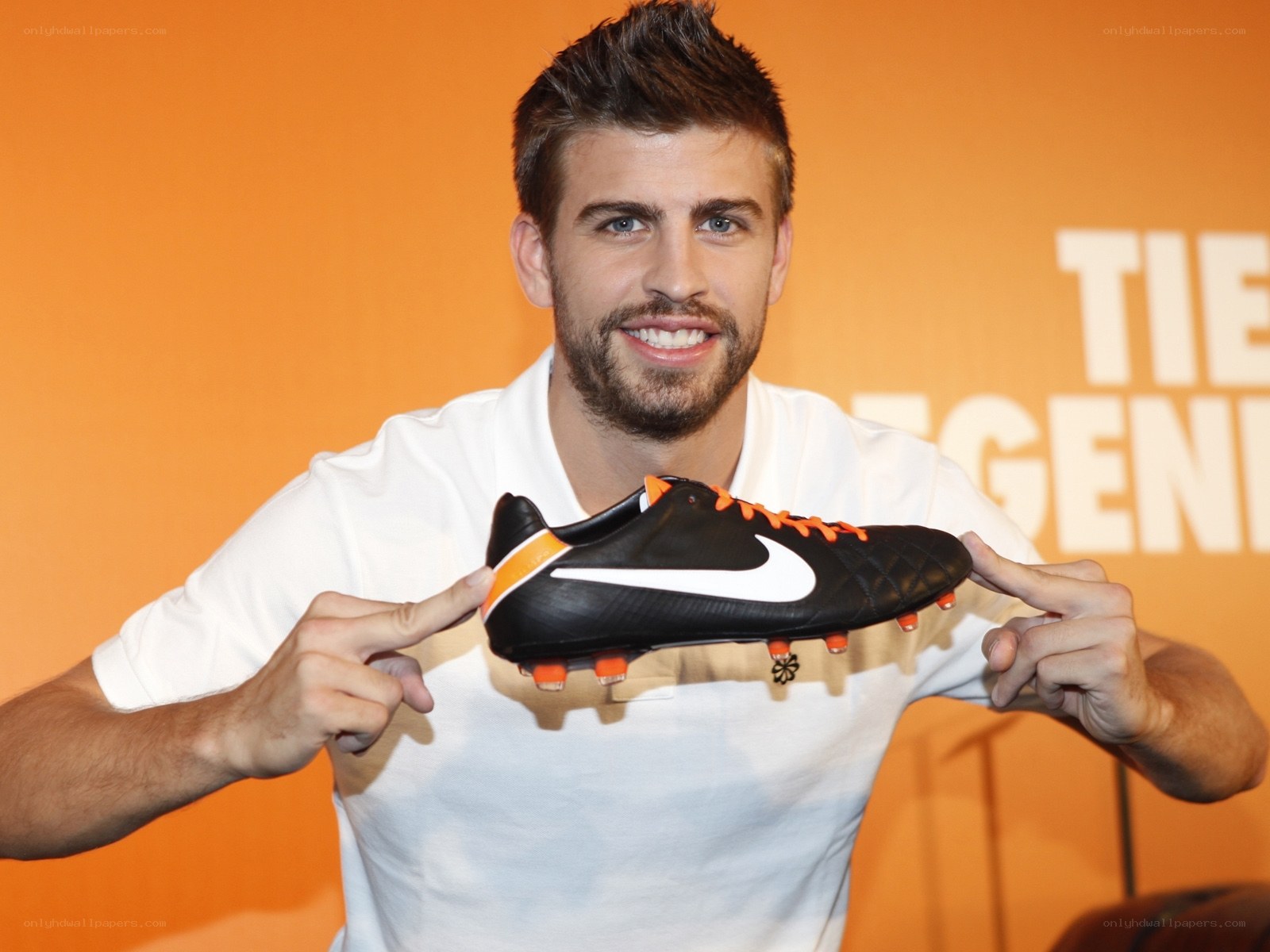 man holding soccer shoe