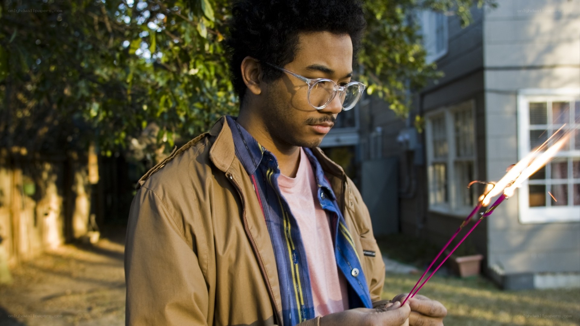 man holding sparklers outside