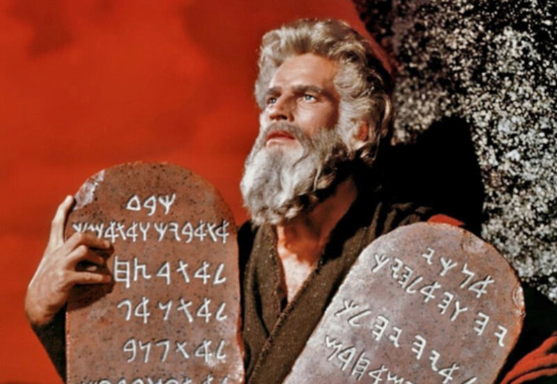 Man Holding Stone Tablets — Red