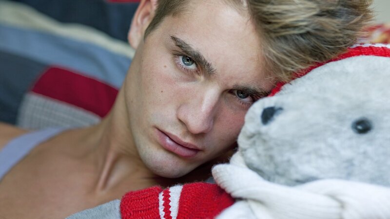 man holding stuffed animal