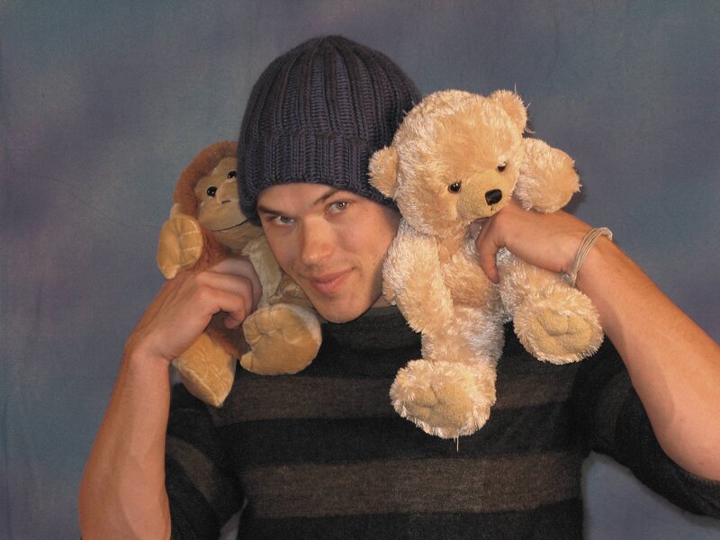 Man holding stuffed animals