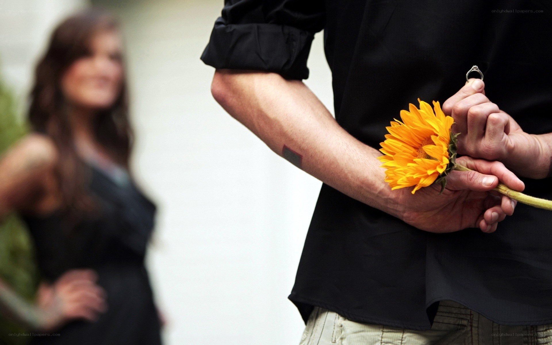 Man holding sunflower and ring