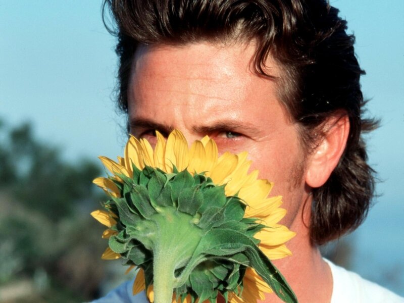 man holding sunflower