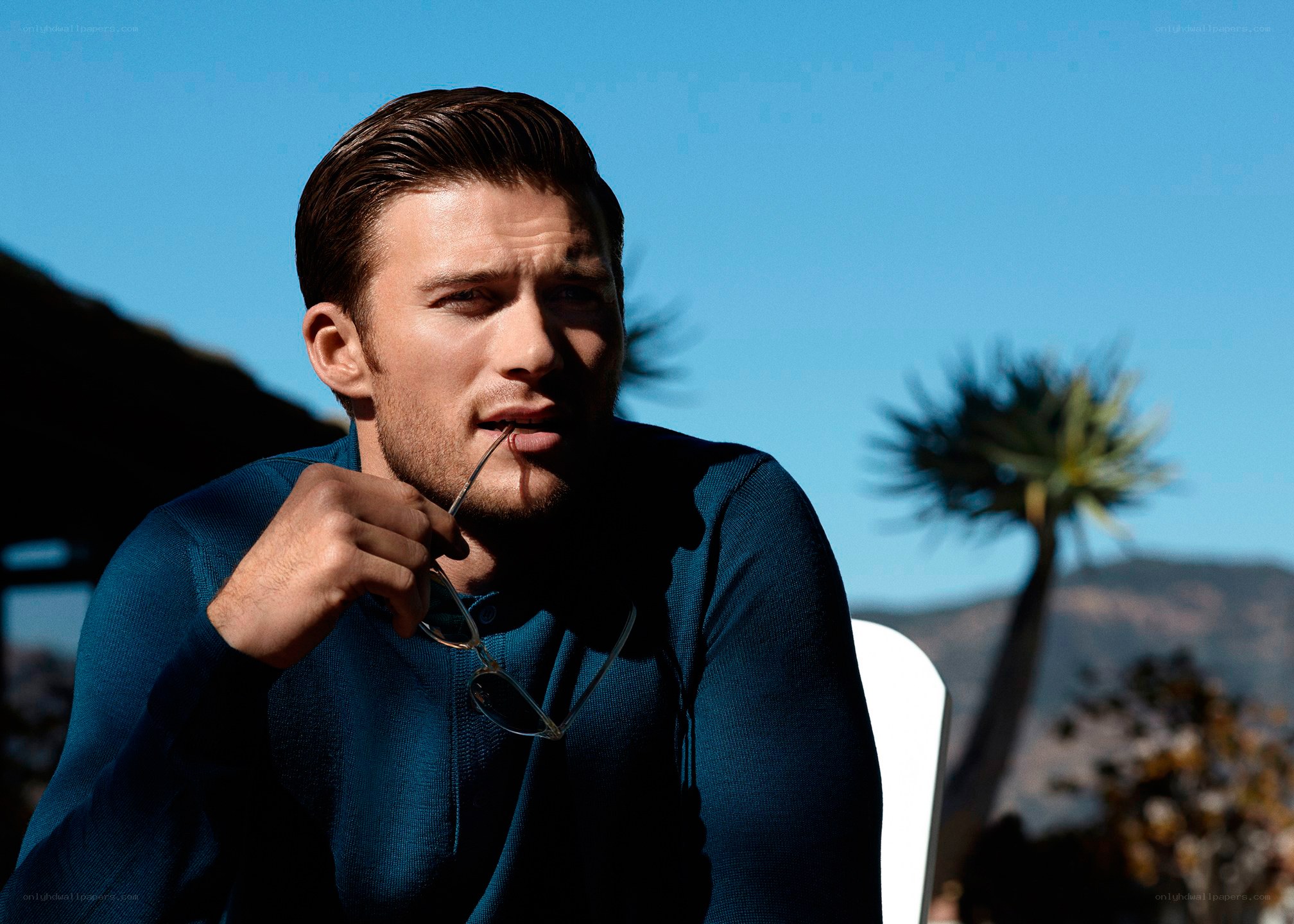 man holding sunglasses outdoors