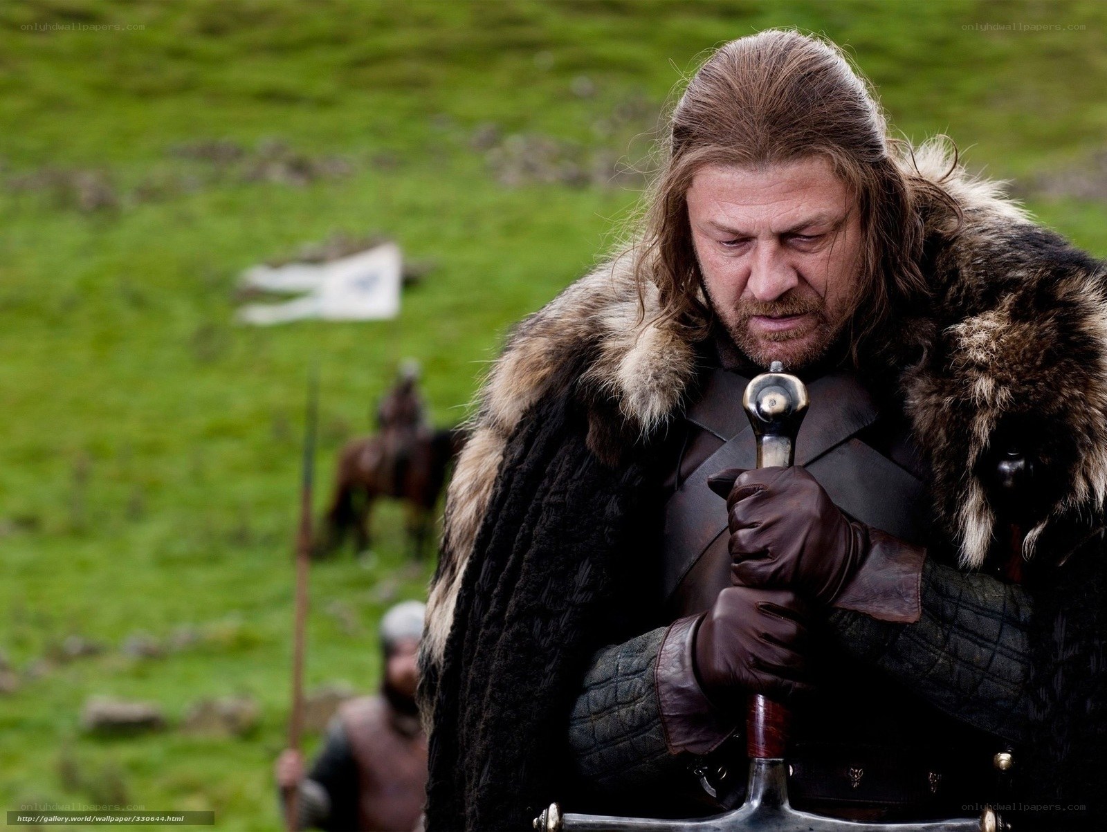 man holding sword in field