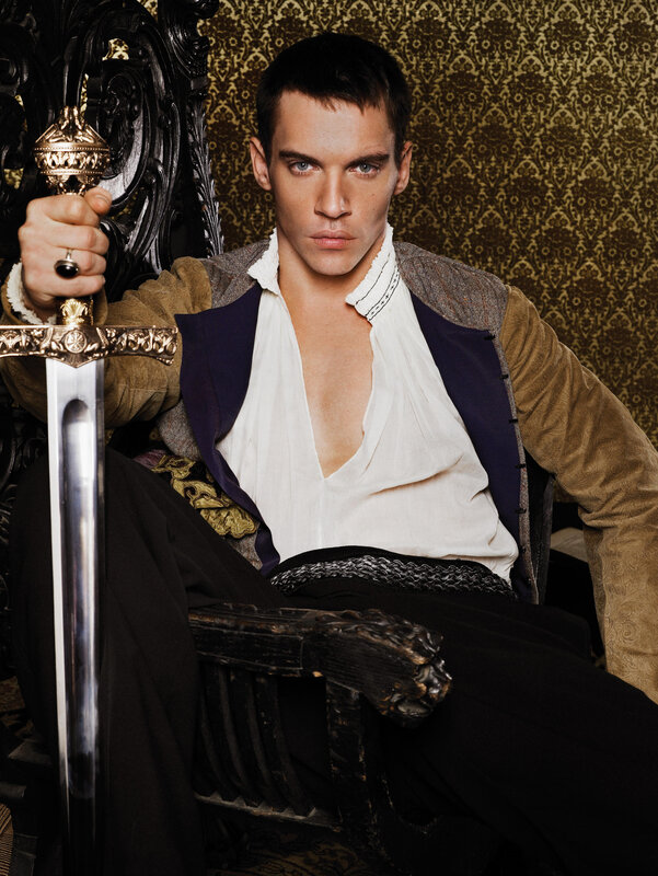 Man holding sword in ornate chair