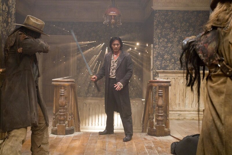 Man Holding Sword in Room